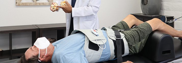 Chiropractor Riverside CA David Landry With Patient On Traction Table